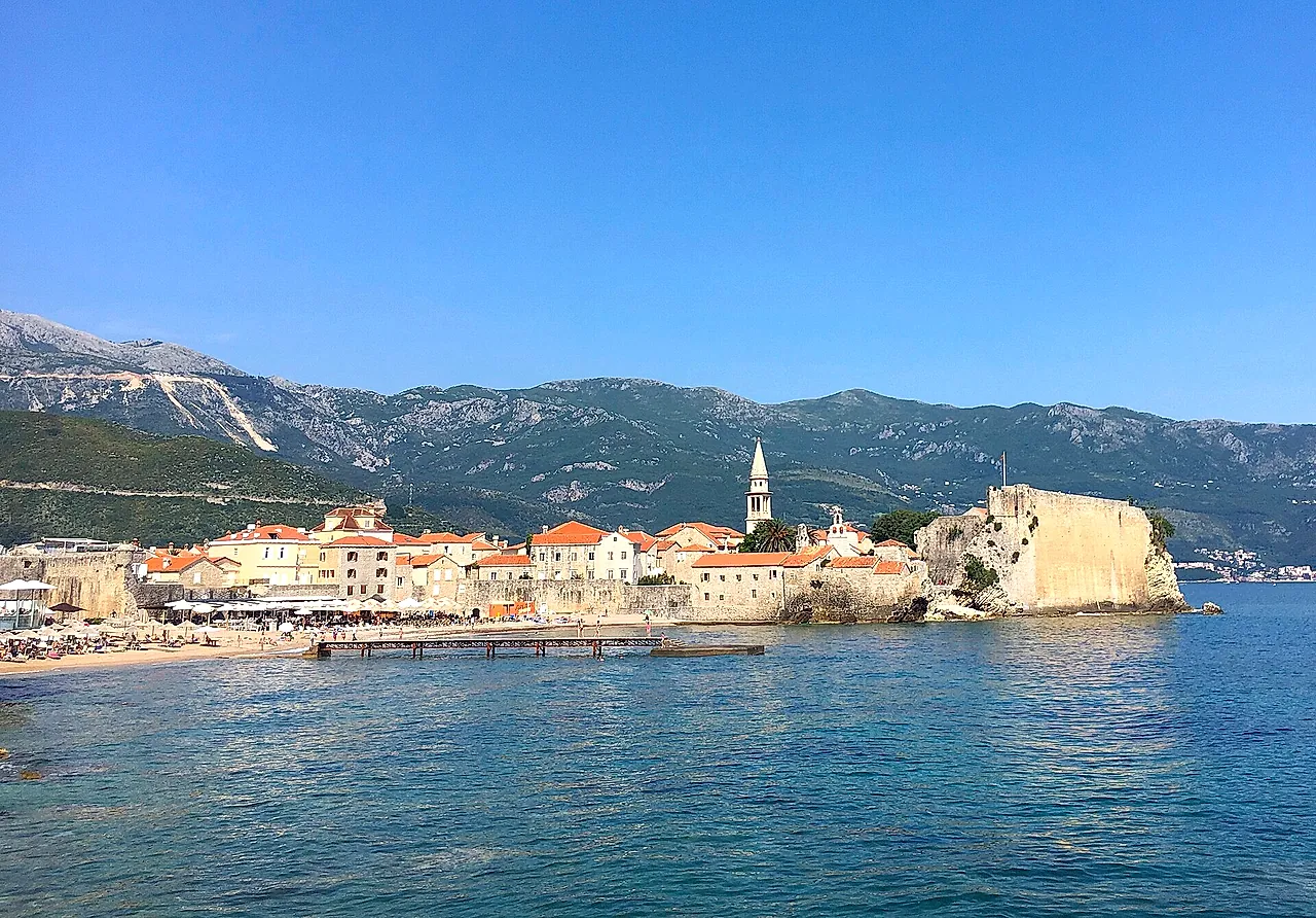 Budva’s old town and its citadel on the promontory, with turquoise sea and mountains