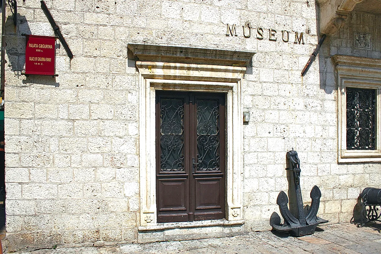 The portal of the Grgurina Palace, home of the Maritime Museum in Kotor, with an anchor beside the door