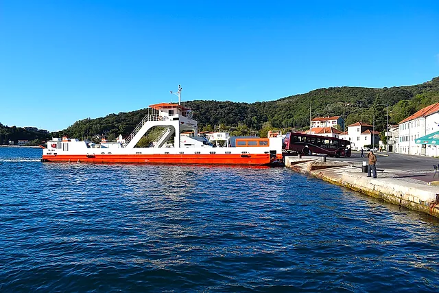 The Teodo ferry moored at Kamenari on the Verige strait, with blue sea and sky